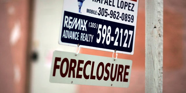 MIAMI - SEPTEMBER 18: A foreclosure sign hangs in front of a home September 18, 2007 in Miami, Florida. According to August numbers released by RealtyTrac, delinquencies and defaults more than doubled versus August 2006 and jumped 36 percent from July. The number is the highest number of foreclosure filings reported in a single month since the company began tracking monthly filings two years ago. (Photo by Joe Raedle/Getty Images)
