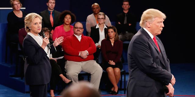 Hillary Clinton (left) and Donald Trump (right) share their positions while Ken Bone (center) listens at the town hall debate on Saturday (Oct. 9).