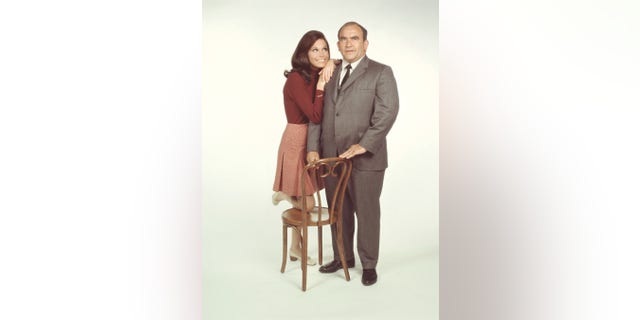 American actors Mary Tyler Moore, as Mary Richards, and Ed Asner, as Lou Grant, pose for a publicity photo for the CBS comedy, "The Mary Tyler Moore Show," in 1971.