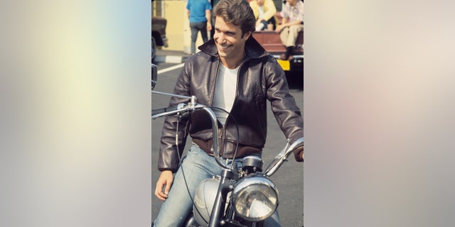 "Happy Days" star Fonzie (Henry Winkler) sits on his motorcycle.