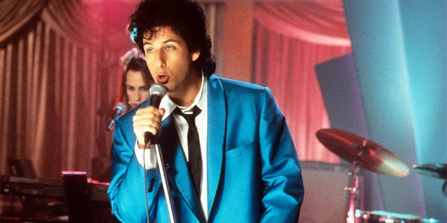 Adam Sandler sings in a scene from "The Wedding Singer," 1998.