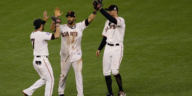 Oct. 25, 2012: San Francisco Giants' Gregor Blanco, left, Angel Pagan, middle, and Hunter Pence celebrates after the Giants defeated the Detroit Tigers, 2-0, in Game 2 of baseball's World Series in San Francisco.
