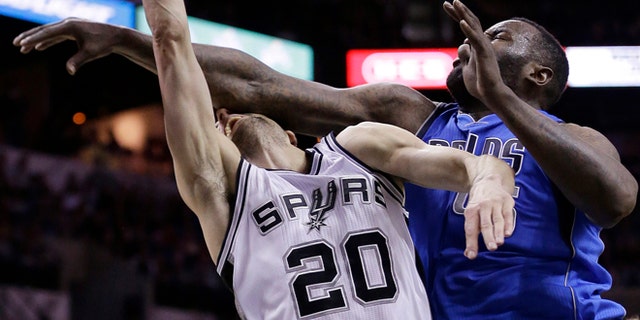 San Antonio Spurs' Manu Ginobili (20), of Argentina, is fouled hard by Dallas Mavericks' DeJuan Blair (45) during the first half of Game 7 of the opening-round NBA basketball playoff series, Sunday, May 4, 2014, in San Antonio. Blair was awarded a flagrant foul on the play.(AP Photo/Eric Gay)