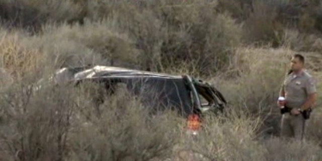 This video frame provided by KABC TV Los Angeles shows a California Highway Patrol officer during an investigation of a crash of an SUV in Action, Calif. on Sunday, March 24, 2013. A 9-year-old girl crawled out of the mangled SUV, climbed out of a canyon and walked about a mile in the middle of the night to find help after surviving the highway crash that killed her father in Southern California, authorities said. (AP Photo/KABC TV)