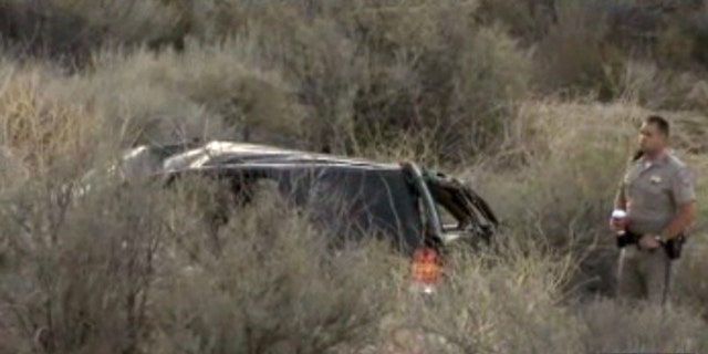 This video frame provided by KABC TV Los Angeles shows a California Highway Patrol officer during an investigation of a crash of an SUV in Action, Calif. on Sunday, March 24, 2013. A 9-year-old girl crawled out of the mangled SUV, climbed out of a canyon and walked about a mile in the middle of the night to find help after surviving the highway crash that killed her father in Southern California, authorities said. (AP Photo/KABC TV)