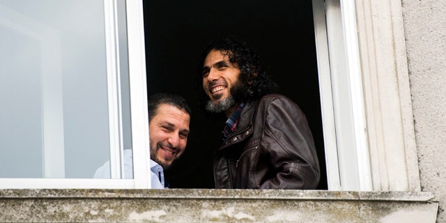 FILE - In this June 5, 2015 file photo, Abu Wa'el Dhiab, from Syria, right, and Adel bin Muhammad El Ouerghi, of Tunisia, both freed Guantanamo Bay detainees, stand next to the window of their shared home in Montevideo, Uruguay. The new U.S. ambassador in Uruguay expressed concern on Monday, July 11, 2016, about the lack of information on the whereabouts of Abu Wa'el Dhiab. (AP Photo/Matilde Campodonico, File)