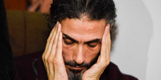 Former Guantanamo detainee Syrian Abu Wa'el Dhiab listens to a question as he holds a press conference at his apartment in Montevideo, Uruguay, Friday, Sept. 30, 2016. Uruguay's government says it is searching for another country to take Dhiab who is threatening to die on a hunger strike if he's not allowed to reunite with his family elsewhere. (AP Photo/Matilde Campodonico)