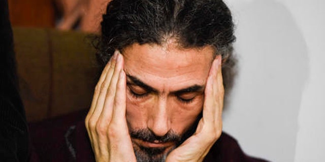 Former Guantanamo detainee Syrian Abu Wa'el Dhiab listens to a question as he holds a press conference at his apartment in Montevideo, Uruguay, Friday, Sept. 30, 2016. Uruguay's government says it is searching for another country to take Dhiab who is threatening to die on a hunger strike if he's not allowed to reunite with his family elsewhere. (AP Photo/Matilde Campodonico)