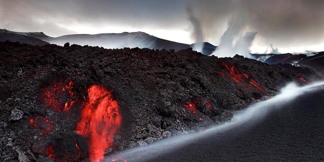 Smoke and steam from the volcano under the Eyjafjallajokull glacier in Iceland have forced hundreds of people to flee rising floodwaters and disrupted plane traffic across Europe.
