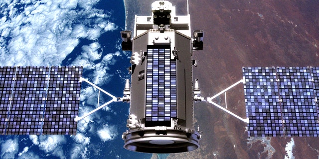 An illustration of the Glory satellite in orbit over the Earth.
