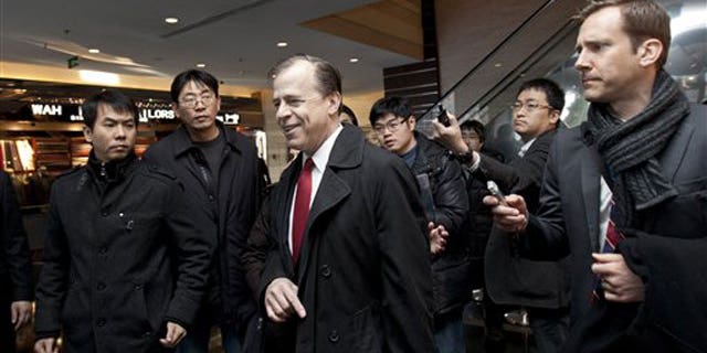 Feb. 23, 2012: U.S. envoy for North Korean Affairs Glyn Davies, center, is surrounded by journalists after giving a statement to media at a hotel in Beijing, China.