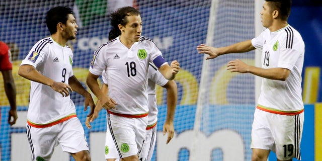 Mexicoâs Andres Guardado, center, is congratulated by teammates Jesus Corona, left, and Oribe Peralta after scoring on a penalty kick during the second half of a CONCACAF Gold Cup soccer semifinal against Panama on Wednesday, July 22, 2015, in Atlanta. (AP Photo/David Goldman)