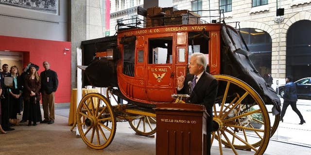 Wells Fargo CEO John Stumpf gestures while speaking during a media conference Thursday, Feb. 19, 2015, in San Francisco. The popular history museum in the heart of San Francisco's financial district is reopening weeks after thieves smashed a stolen vehicle through its front door and made off with historic gold nuggets on display. (AP Photo/Ben Margot)