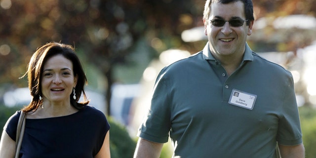 July 10, 2013: In this file photo, Sheryl Sandberg, COO of Facebook, left, and her husband David Goldberg, CEO of SurveyMonkey, walk to the morning session at the Allen & Company Sun Valley Conference in Sun Valley, Idaho.