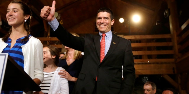 Republican candidate for the U.S. Senate Gabriel Gomez, center, gives a thumbs up as he takes to the stage next to his daughter Olivia, 13, left, before addressing an audience with a victory speech at a watch party, in Cohasset, Mass., Tuesday, April 30, 2013. Gomez won his primary bid for the Republican nomination to contest a U.S. Senate seat, defeating Republican hopefuls Michael Sullivan and Dan Winslow. (AP Photo/Steven Senne)