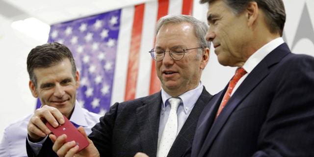 Sept. 10, 2013: Google Executive Chairman Eric Schmidt, center, helps Texas Gov. Rick Perry with his smart phone as Dennis Woodside, Motorola CEO, looks on during the opening ceremony for a Motorola smartphone factory in Texas.
