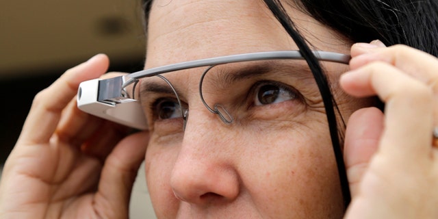Dec. 3, 2013: Cecilia Abadie models her Google Glass as she talks with her attorney outside of traffic court in San Diego. When Abadie was pulled over on suspicion of speeding in October, the officer saw she was wearing Google Glass and tacked on a citation usually given to drivers who may be distracted by a video or TV screen. She pleaded not guilty to both charges on Tuesday.