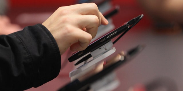 HANOVER, GERMANY - MARCH 06: A visitor tries out Microsoft-driven smartphones on the first day of the CeBIT 2012 technology trade fair on March 6, 2012 in Hanover, Germany. CeBIT 2012, the world's largest information technology trade fair, will run from March 6-10, and advances in cloud computing and security are major features this year. (Photo by Sean Gallup/Getty Images)