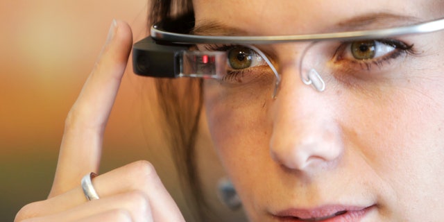 A woman wears Google glasses after a media presentation of a Google apartment in Prague May 15, 2014.