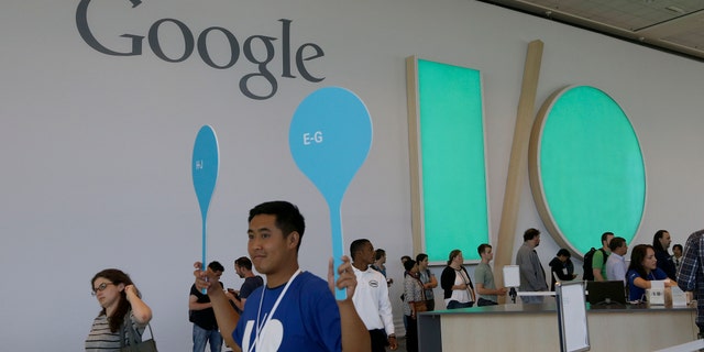 A Google employee helps direct people as they register for Google I/O 2014 in San Francisco.