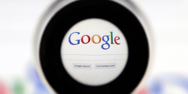 A Google search page is seen through a magnifying glass in this photo illustration taken in Brussels May 30, 2014. Google has taken the first steps to meet a European ruling that citizens can have objectionable links removed from Internet search results, a ruling that pleased privacy campaigners but raised fears that the right can be abused to hide negative information. REUTERS/Francois Lenoir (BELGIUM - Tags: SCIENCE TECHNOLOGY POLITICS) - RTR3RK8U