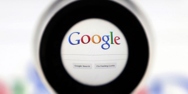 A Google search page is seen through a magnifying glass in this photo illustration taken in Brussels May 30, 2014. Google has taken the first steps to meet a European ruling that citizens can have objectionable links removed from Internet search results, a ruling that pleased privacy campaigners but raised fears that the right can be abused to hide negative information. REUTERS/Francois Lenoir (BELGIUM - Tags: SCIENCE TECHNOLOGY POLITICS) - RTR3RK8U