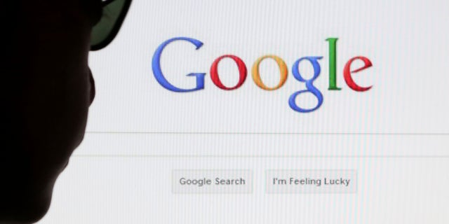 A computer user poses in front of a Google search page in this photo illustration taken in Brussels May 30, 2014. Google has taken the first steps to meet a European ruling that citizens can have objectionable links removed from Internet search results, a ruling that pleased privacy campaigners but raised fears that the right can be abused to hide negative information. REUTERS/Francois Lenoir (BELGIUM - Tags: POLITICS SCIENCE TECHNOLOGY) - RTR3RK9T