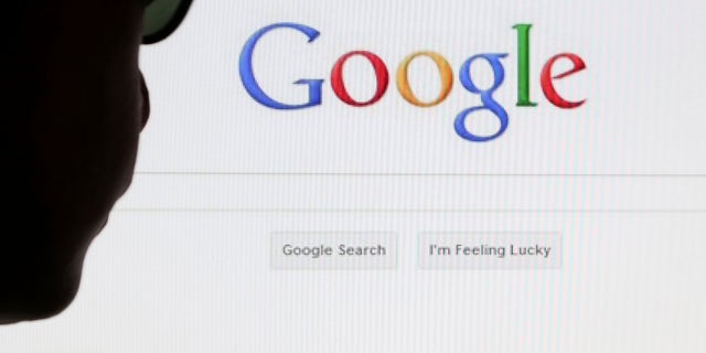 A computer user poses in front of a Google search page in this photo illustration taken in Brussels May 30, 2014. Google has taken the first steps to meet a European ruling that citizens can have objectionable links removed from Internet search results, a ruling that pleased privacy campaigners but raised fears that the right can be abused to hide negative information.   REUTERS/Francois Lenoir (BELGIUM - Tags: POLITICS SCIENCE TECHNOLOGY) - RTR3RK9T