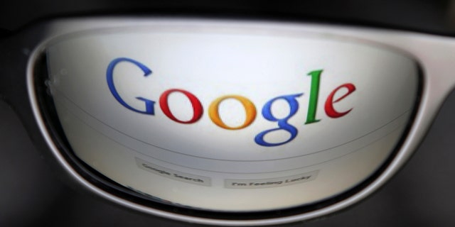 A Google search page is reflected in sunglasses in this photo illustration taken in Brussels May 30, 2014. Google has taken the first steps to meet a European ruling that citizens can have objectionable links removed from Internet search results, a ruling that pleased privacy campaigners but raised fears that the right can be abused to hide negative information. REUTERS/Francois Lenoir (BELGIUM - Tags: POLITICS SCIENCE TECHNOLOGY) - RTR3RK9G