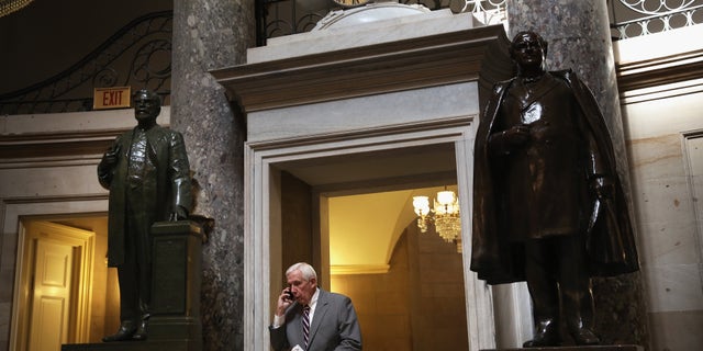 WASHINGTON, DC - OCTOBER 03: U.S. Rep. Frank Wolf (R-VA) talks on his cellular phone as he passes through the Statuary Hall at the Capitol October 3, 2013 on Capitol Hill in Washington, DC. (Photo by Alex Wong/Getty Images)
