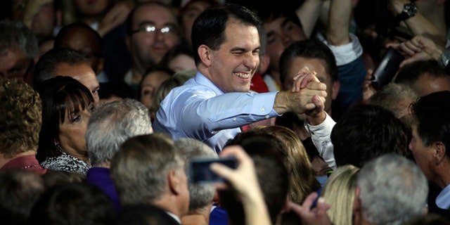 Wisconsin Republican Gov. Scott Walker shakes hands after speaking at his campaign party Tuesday, Nov. 4, 2014, in West Allis, Wis. Walker defeated Democratic gubernatorial challenger Mary Burke. (AP Photo/Morry Gash)