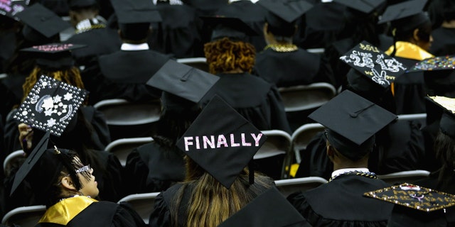 COLLEGE PARK, MD - MAY 17: Graduates of Bowie State University put messages on their mortarboard hats during the school's graduation ceremony at the Comcast Center on the campus of the University of Maryland May 17, 2013 in College Park, Maryland. First lady Michelle Obama delivered the commencement speech for the 600 graduates of Maryland's oldest historically black university and one of the ten oldest in the country. (Photo by Chip Somodevilla/Getty Images)