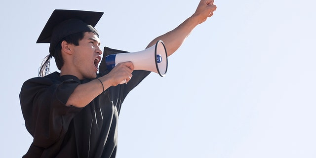 File image of a graduate. Two students at a Catholic high school were told they couldn't give their speeches because they were too political and inconsistent with Catholic teachings, so they delivered them with a bullhorn outside the ceremony instead.