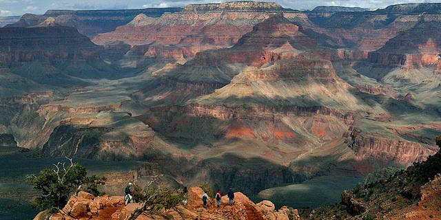 With the North Rim in the background, tourists hike along the South Rim of the Grand Canyon Tuesday, Feb. 22, 2005.