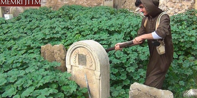 ISIS released images on Thursday that show members destroying Christian graves in the northern Iraqi city of Mosul. (courtesy of MEMRI)