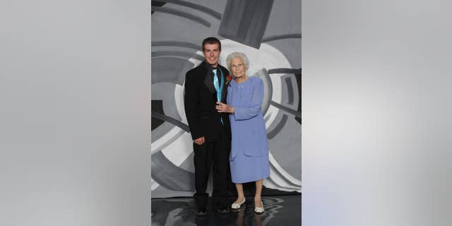 This photo provided by Inter-State Studio & Publishing Co. Shows Drew Holm and his great-grandmother Kathryn Keith in their prom picture. The Indiana teenager who took 93-year-old Keith to his junior prom says he had a great time, even though her early bedtime nearly cut the night short. Holm then took his girlfriend to an after-prom event at a bowling alley. (Inter-State Studio & Publishing Co. via AP)
