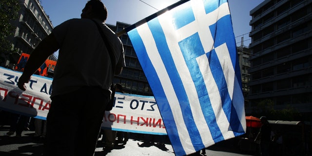ATHENS, GREECE - NOVEMBER 6: Protesters march outside parliament during a rally on November 6, 2012 in Athens, Greece. Thousands of Greeks are protesting against further austerity measures as a two-day general strike begins ahead of a crucial Parliamentary vote for emergency cuts and tax increases. (Photo Milos Bicanski/Getty Images)