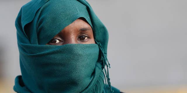 An African immigrant, one of the 32 from Syria and Somalia who survived from one of the deadliest migrant boat accidents which occurred on May 5 in Greek waters, arrives at the port of Piraeus, near Athens, on Monday, May 12, 2014. At least 22 people, including families trapped in a flooded cabin, drowned when a yacht and a dinghy crammed with migrants trying to slip into Greece capsized last week in the eastern Aegean Sea, next to the island of Samos, authorities said. (AP Photo/Petros Giannakouris)