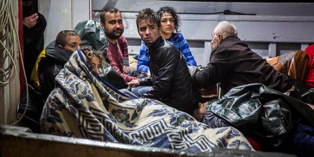 Oct. 28, 2015: Refugees arrive to the port of Molivos on a fishing boat after the boat in which they were crossing the Aegean sea from Turkey to the Greek island of Lesbos sank. (AP Photo/Santi Palacios)