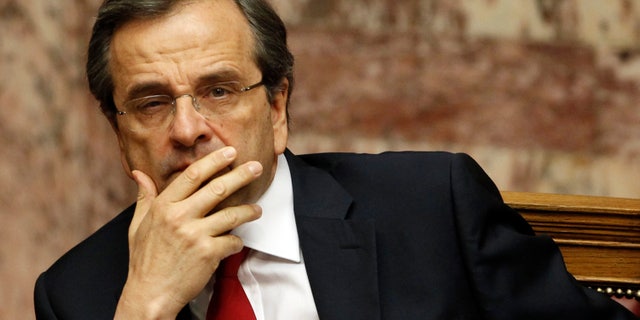 Greek Prime Minister Antonis Samaras looks on during a debate on the new government's policy agenda before staging a vote of confidence at the parliament in Athens, late Sunday July 8, 2012. (AP Photo/Kostas Tsironis)