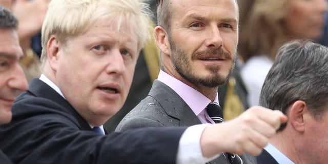 May 17, 2012: Former England football captain David Beckham, right, and London Mayor Boris Johnson attend a handover for the Olympic flame at Panathenaean stadium in Athens.