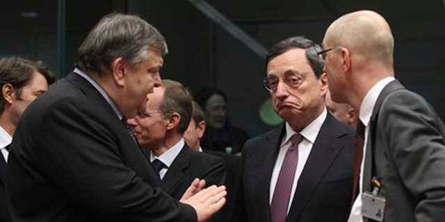 Feb. 20, 2012: Greek Finance Minister Evangelos Venizelos, left, gestures while speaking with European Central Bank President Mario Draghi, second right, during a round table meeting of eurozone finance ministers at the EU Council building in Brussels.