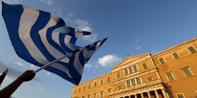 File photo - A protester waves a Greek flag during an anti-austerity rally in Athens, Greece, June 29, 2015.