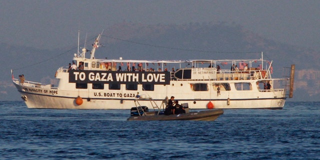 July 1: The activist run boat “Audacity of Hope” is escorted by the Greek coast guard in port of Perama, near Athens, Greece.