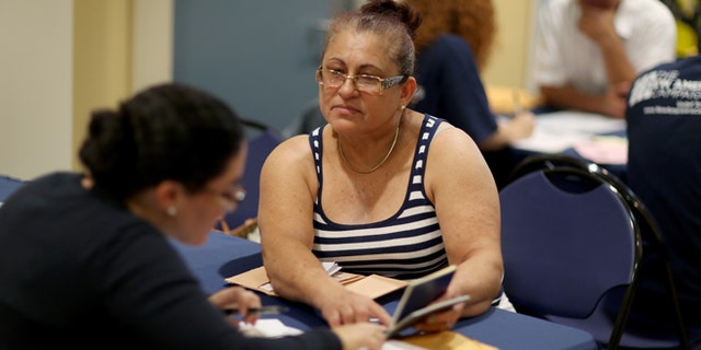 MIAMI, FL - SEPTEMBER 13: Gloria Lopez, originally from Nicaragua, sits with Jaclyn O'Connor, a Florida International University law school graduate, as she receives help in applying for United States citizenship September 13, 2014 in Miami, Florida. The clinic put on by the Florida New Americans (FNA) program, an initiative of the Florida Immigrant Coalition, provides legal assistance, study materials and information to Floridians applying for U.S. citizenship. Today, the program partnered with the Florida International University and Catholic Legal Services of the Archdiocese of Miami, to assist current eligible green-card holders with their citizenship application. (Photo by Joe Raedle/Getty Images)