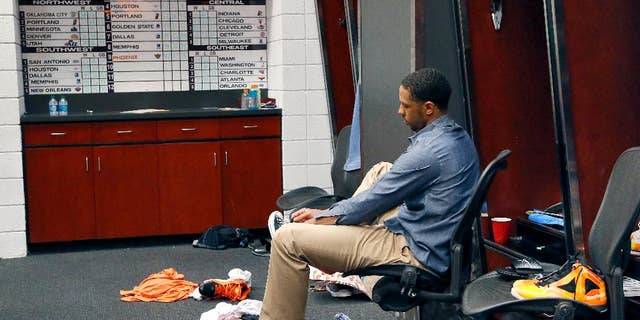 Phoenix Suns' Channing Frye laces up his shoe in the locker room after an NBA basketball game against the Memphis Grizzlies, Monday, April 14, 2014, in Phoenix. The Grizzlies won 97-91 eliminating the Suns from the playoffs. (AP Photo/Matt York)