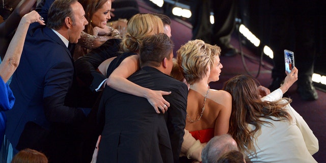 This March 2, 2014 file photo shows Kevin Spacey, from left, Angelina Jolie, Julia Roberts, Brad Pitt, Jennifer Lawrence, Ellen Degeneres and Jared Leto join other celebrities for a group selfie during the Oscars at the Dolby Theatre in Los Angeles.