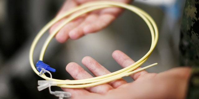 Nov. 20, 2013: In this photo, reviewed by the U.S. military, U.S. Navy medical personnel displays an enteral feeding tube, used for force-feeding detainees, during a tour of the detainee hospital at Guantanamo Bay Naval Base, Cuba.