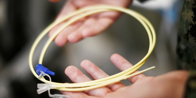 Nov. 20, 2013: In this photo, reviewed by the U.S. military, U.S. Navy medical personnel displays an enteral feeding tube, used for force-feeding detainees, during a tour of the detainee hospital at Guantanamo Bay Naval Base, Cuba.