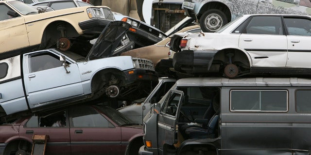 RICHMOND, CA - JULY 31: Junk cars are seen stacked at Deal Auto Wrecking July 31, 2009 in Richmond, California. Federal lawmakers are seeking an additional $2 billion to keep the popular "Cash For Clunkers" program going after the initial $1 billion in funding ran out after a week. (Photo by Justin Sullivan/Getty Images)